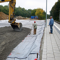 Excavadora coloca balasto sobre Basetrac® Duo-C